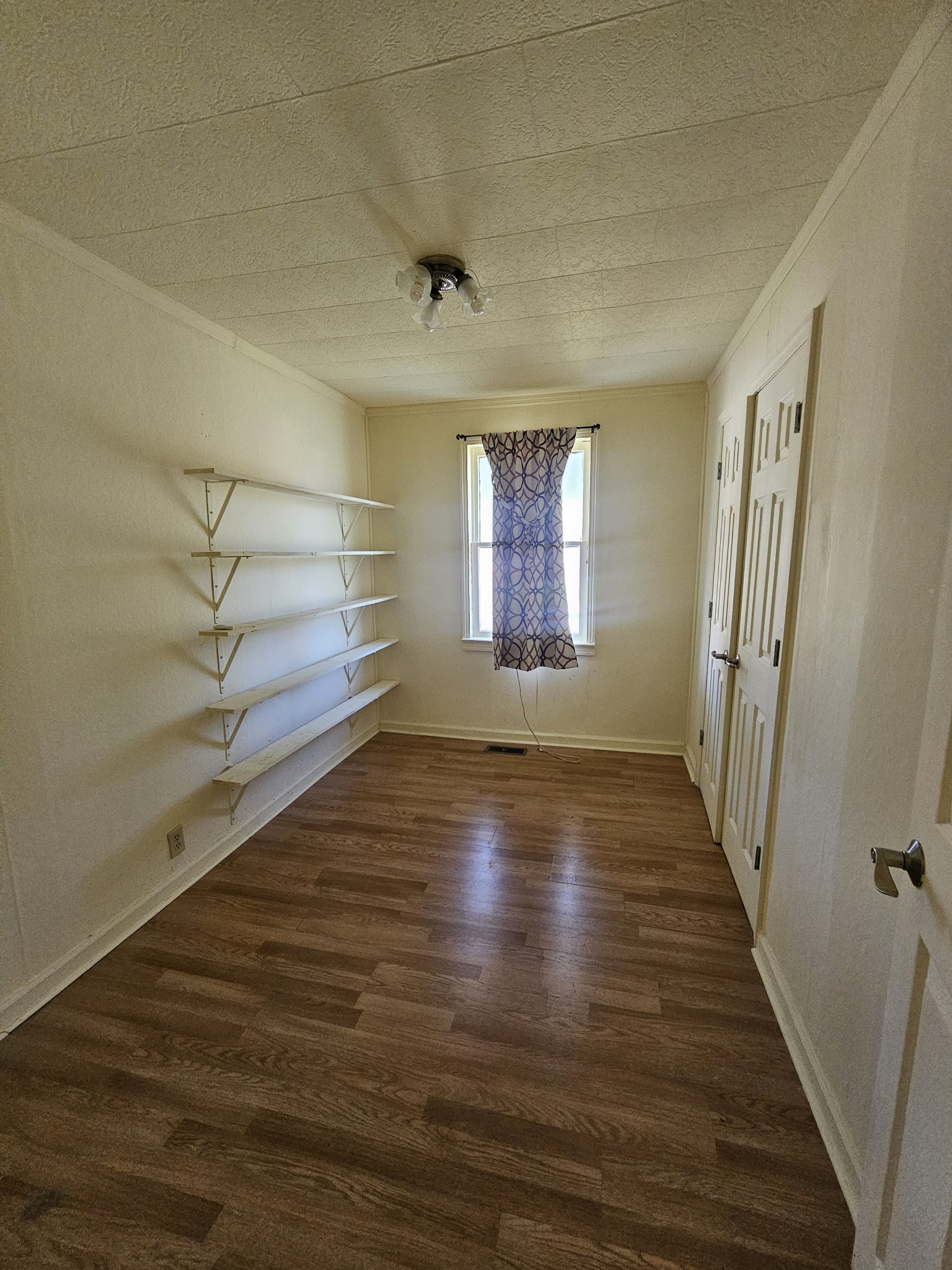105 East Market Street Decherd, TN 37324 - Photo 7 of 12 a view of empty room with wooden floor and fan