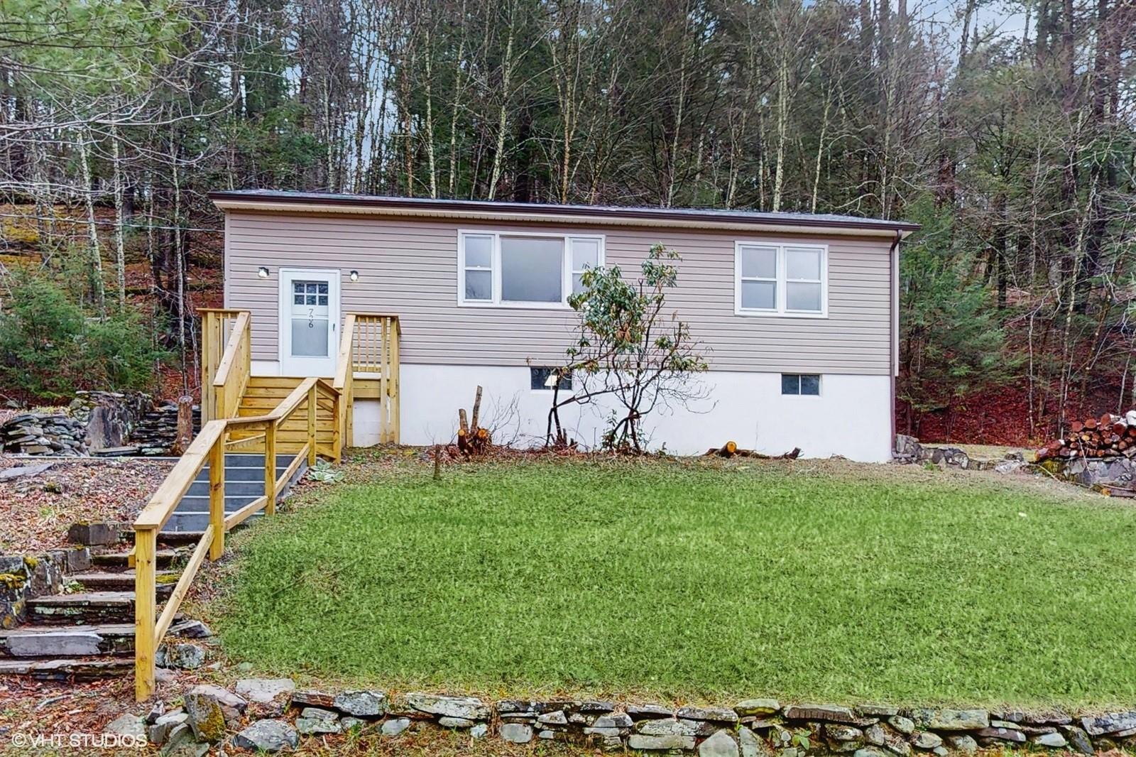 a view of a house with backyard and sitting area