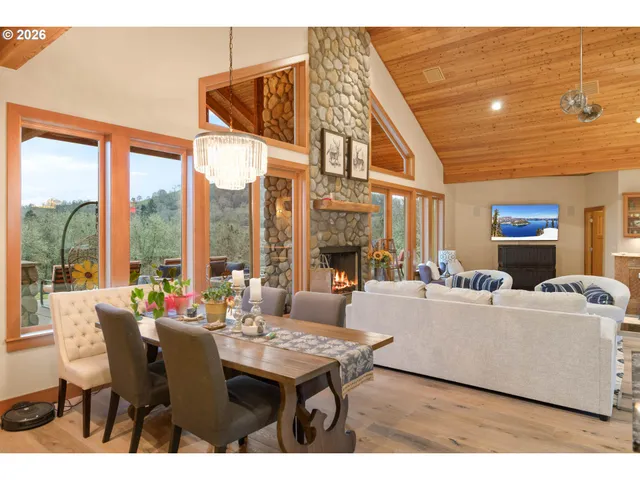 a living room with furniture a table and a large window