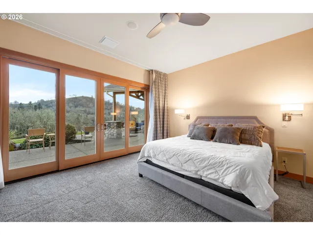 a bedroom with a bed and ceiling fan