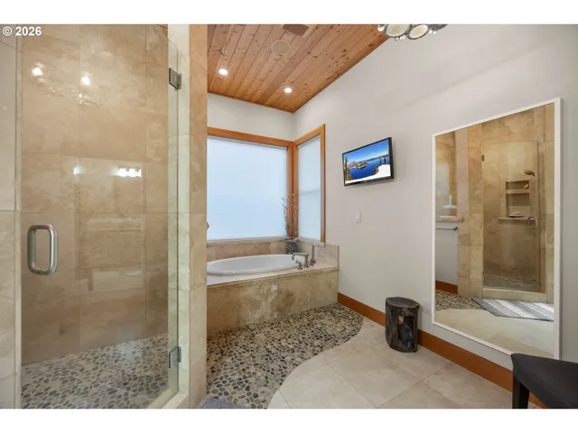 a bathroom with a bathtub and a window