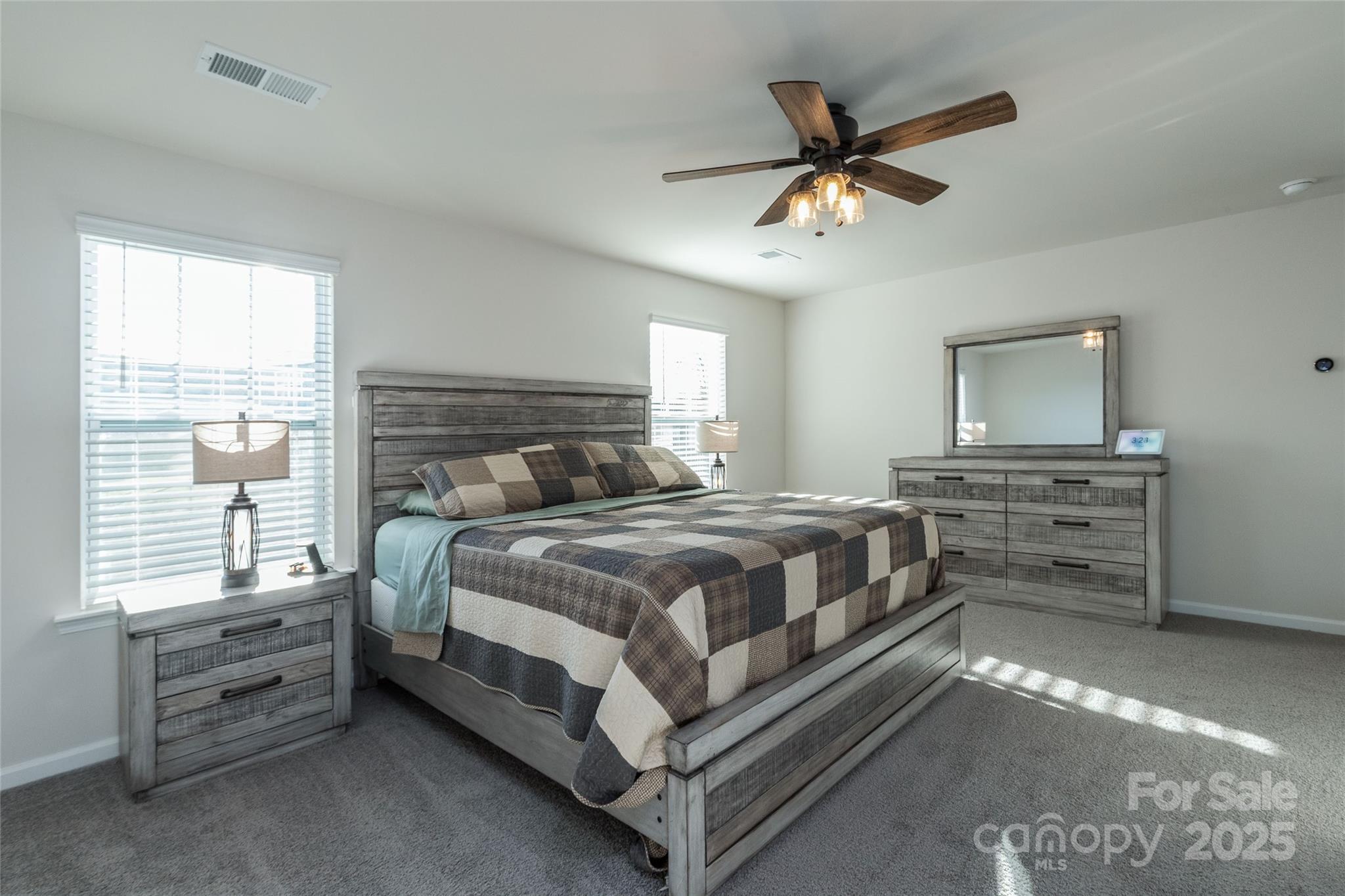 84 Madelyn Drive Clyde, NC 28721 - Photo 15 of 29 a bedroom with a bed and a ceiling fan