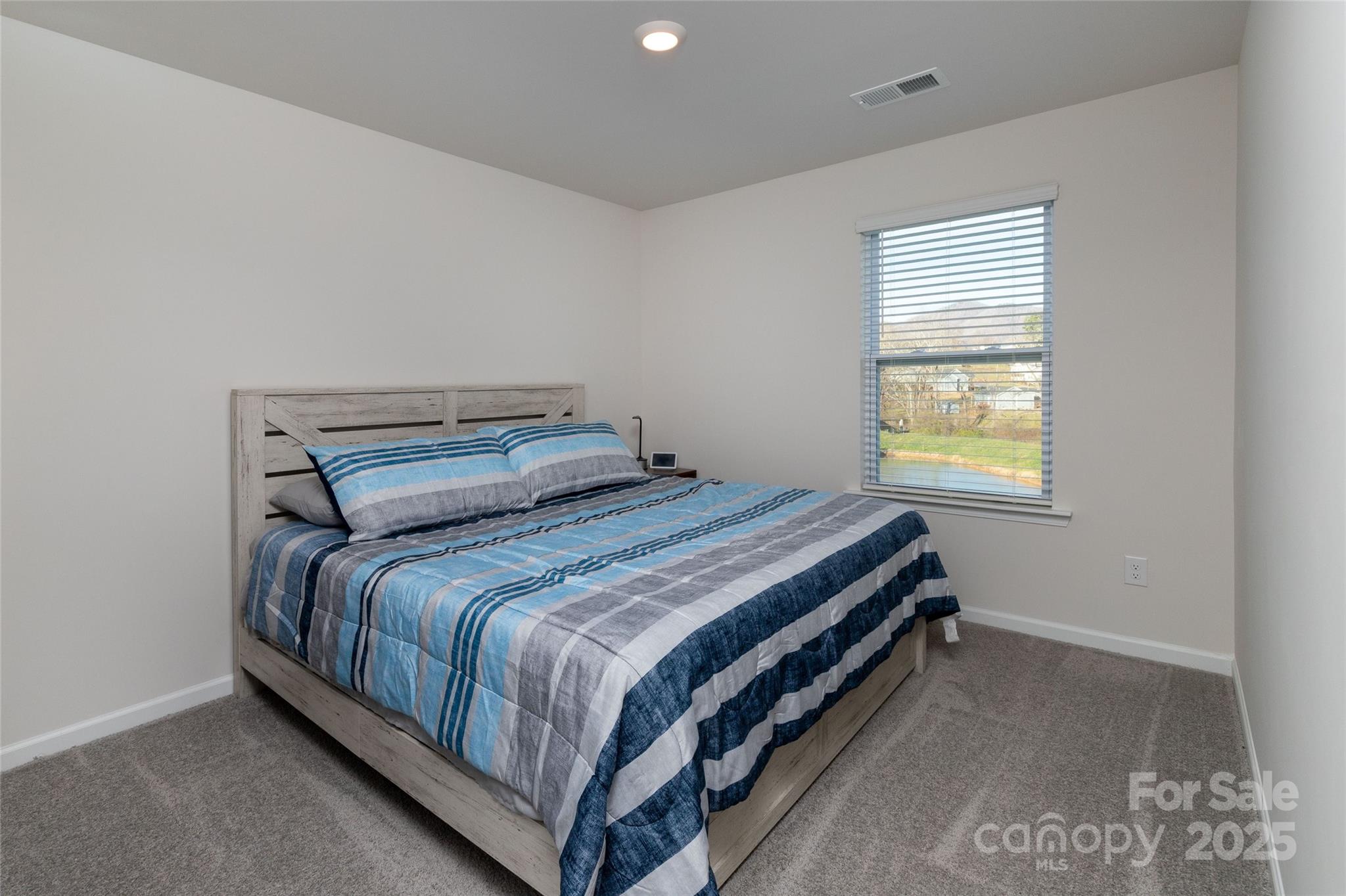 84 Madelyn Drive Clyde, NC 28721 - Photo 19 of 29 a bedroom with a bed and window