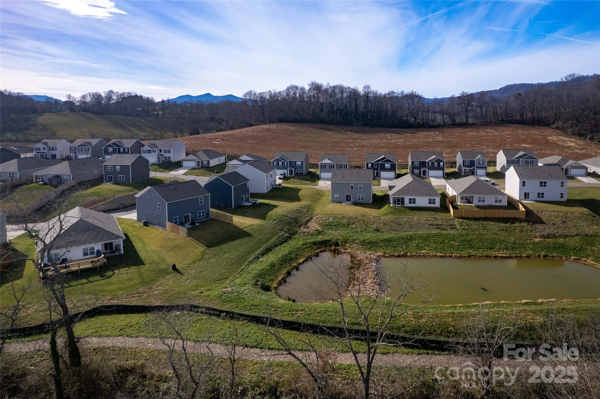 84 Madelyn Drive Clyde, NC 28721 - Photo 23 of 29 a view of a lake in middle of the town