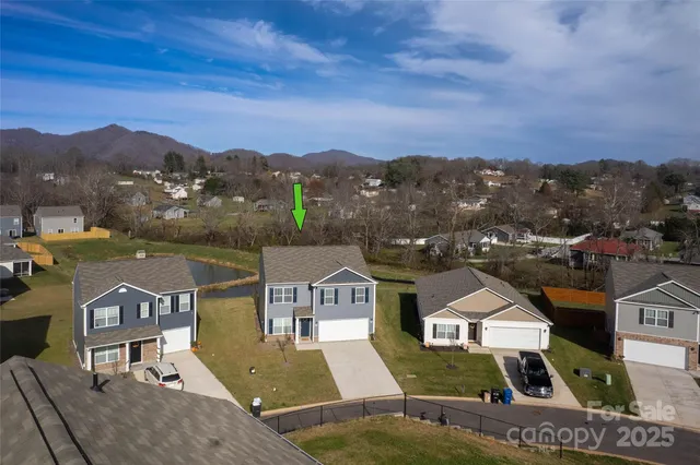 an aerial view of a house with a big yard