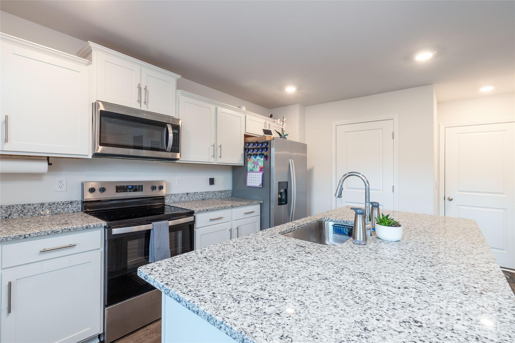 84 Madelyn Drive Clyde, NC 28721 - Photo 9 of 29 a kitchen with stainless steel appliances granite countertop a stove microwave and sink
