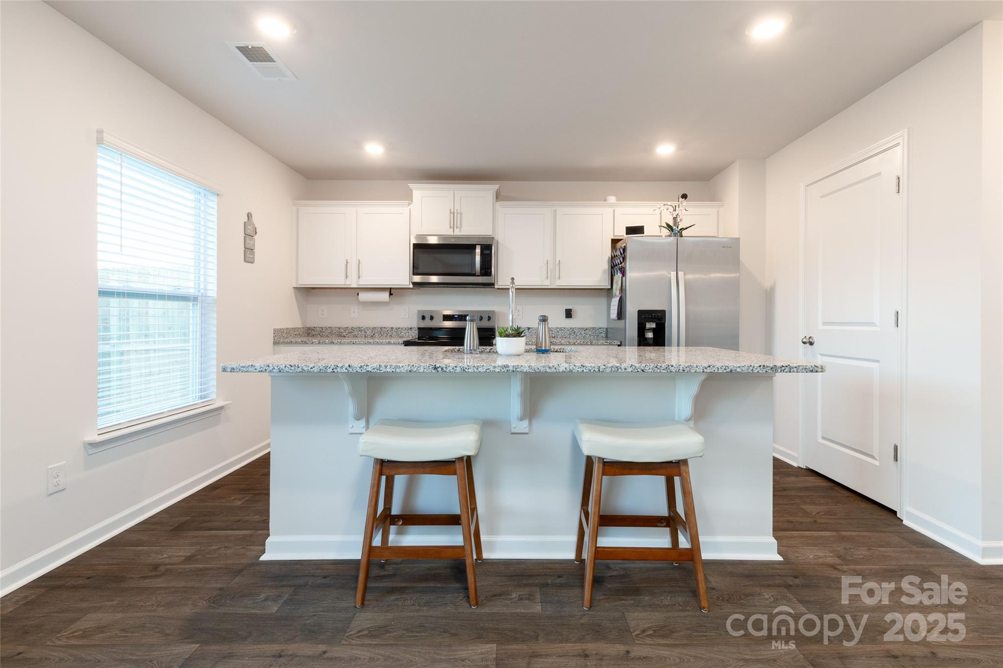 84 Madelyn Drive Clyde, NC 28721 - Photo 10 of 29 a kitchen with kitchen island granite countertop a sink a stove a refrigerator cabinets and a dining table