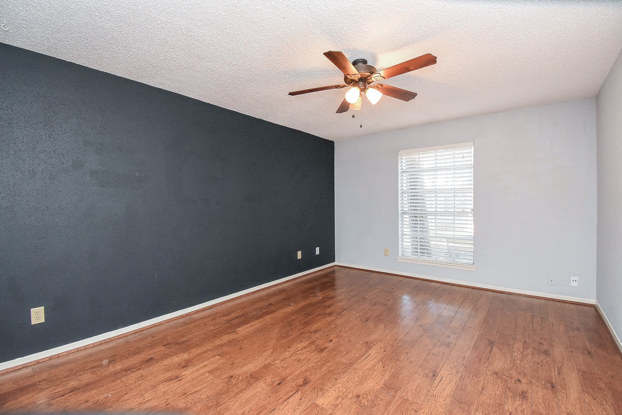 9107 Wallingham Court Spring, TX 77379 - Photo 16 of 25 a view of an empty room with wooden floor and a window