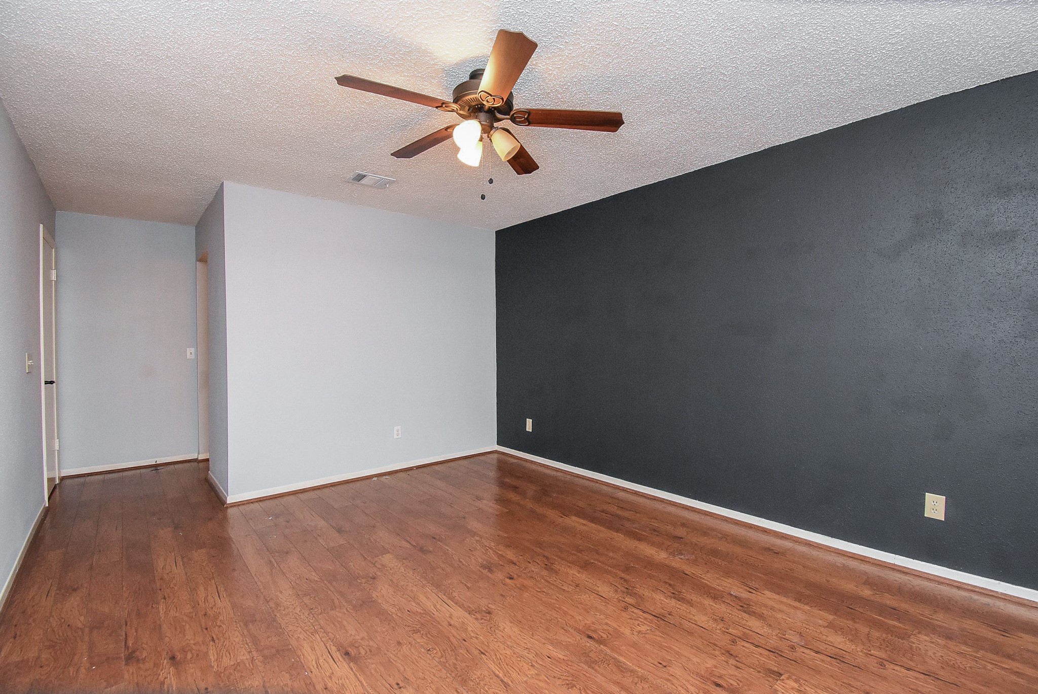 9107 Wallingham Court Spring, TX 77379 - Photo 17 of 25 a view of an empty room with wooden floor