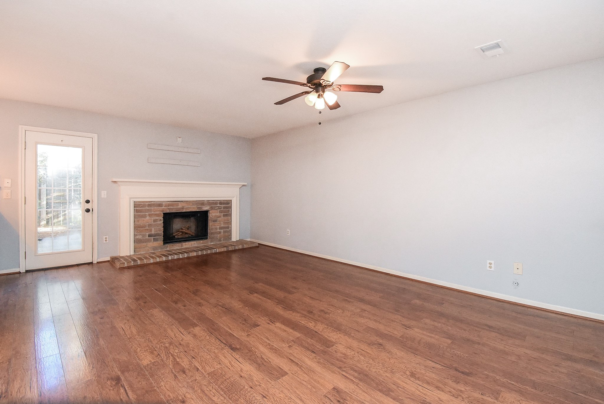 9107 Wallingham Court Spring, TX 77379 - Photo 7 of 25 a view of empty room with wooden floor and fireplace
