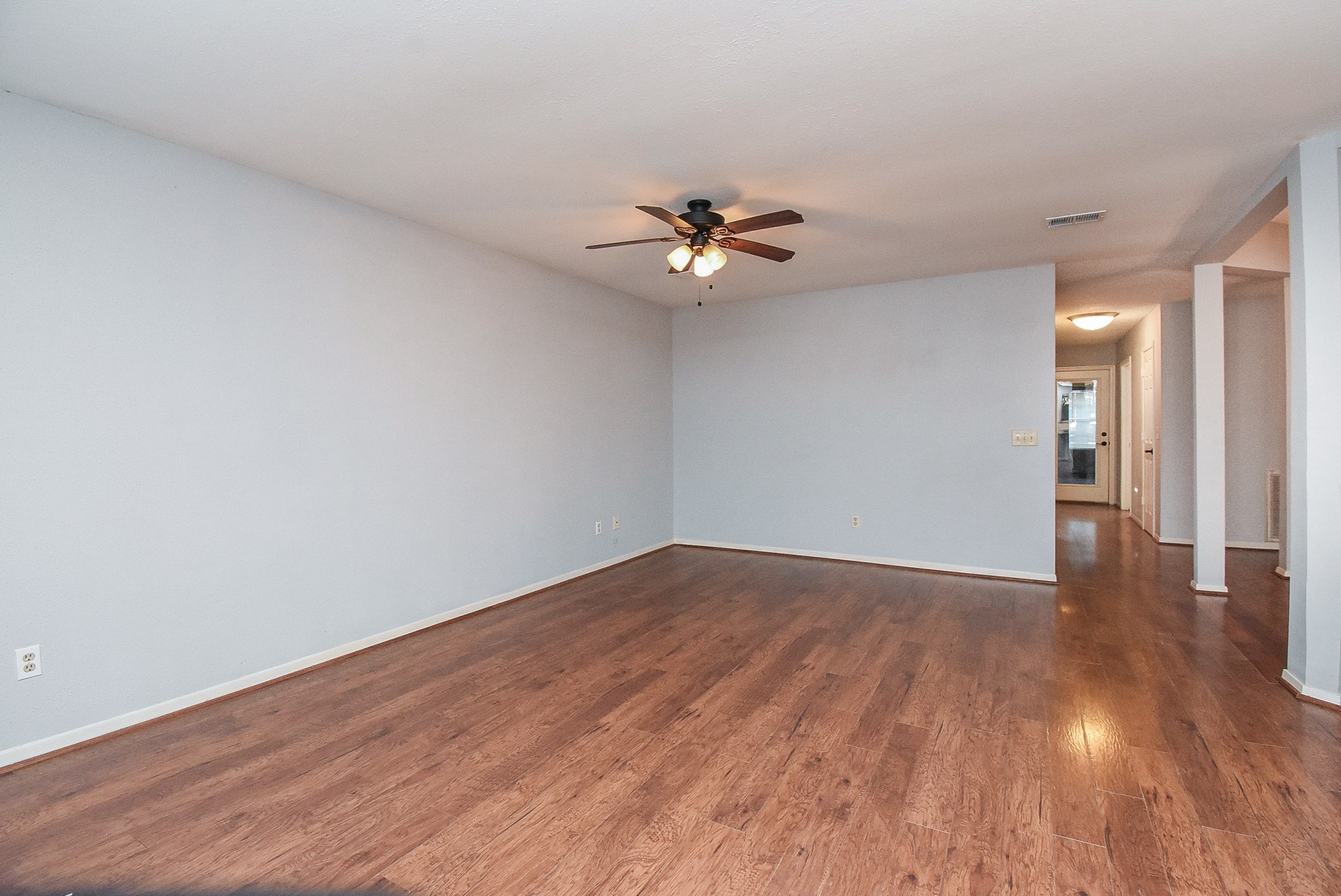 9107 Wallingham Court Spring, TX 77379 - Photo 10 of 25 a view of an empty room with wooden floor