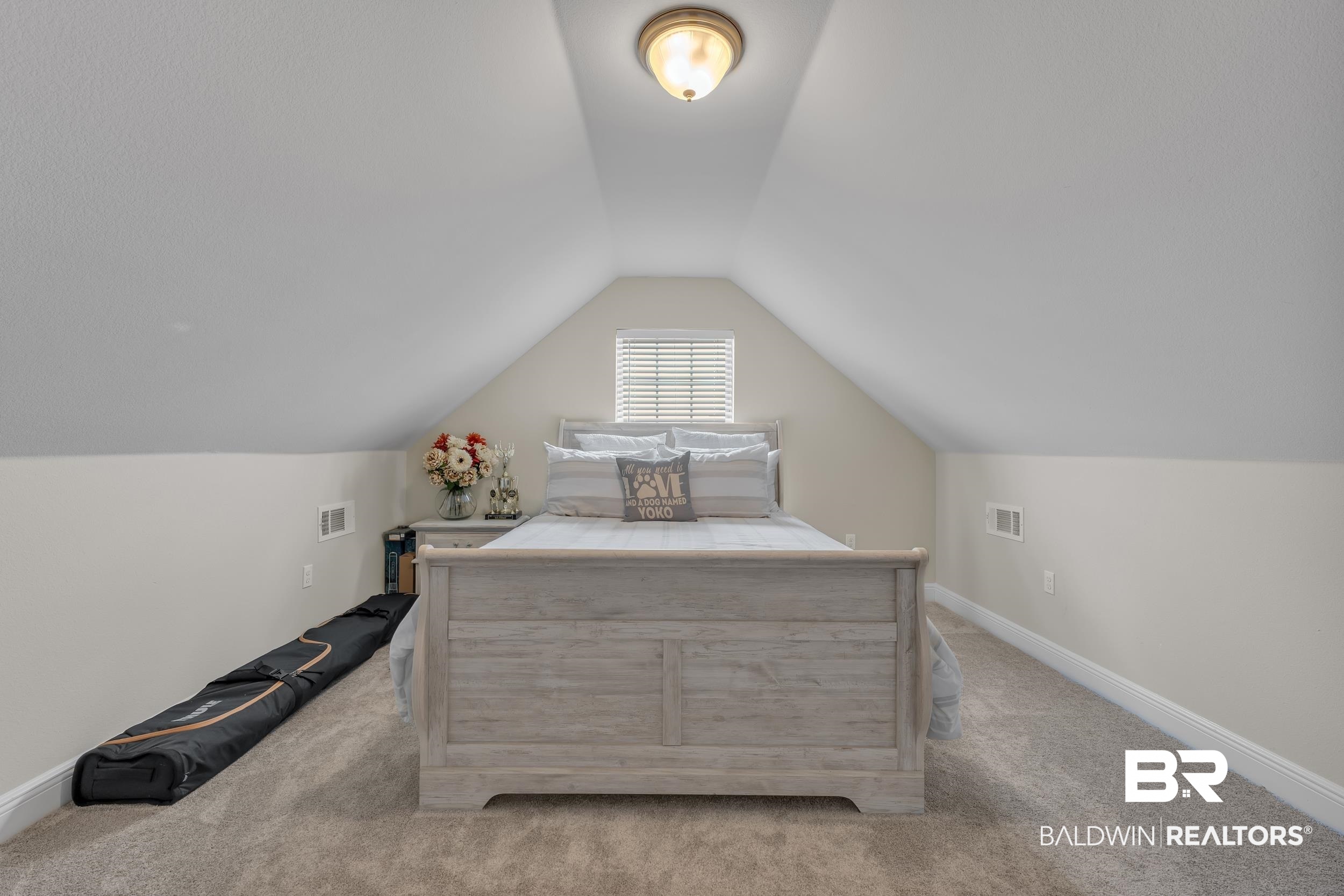 7109 Rocky Rd Loop Gulf Shores, AL 36542 - Photo 27 of 30 Bedroom with vaulted ceiling, carpet, baseboards, and visible vents
