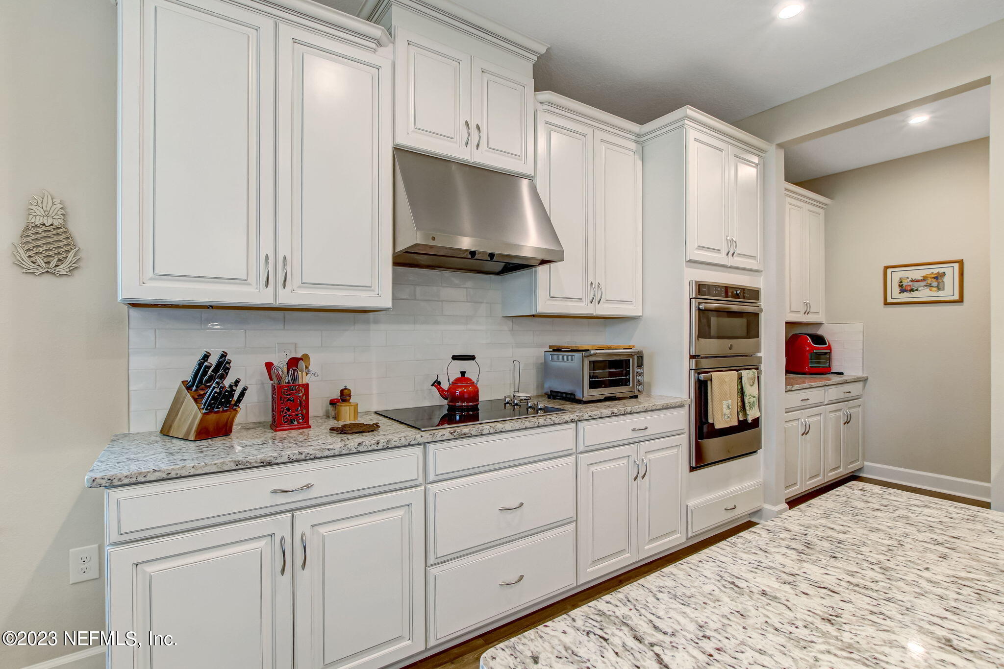 85276 Berryessa Way Yulee, FL 32097 - Photo 15 of 42 a kitchen with white cabinets and white appliances