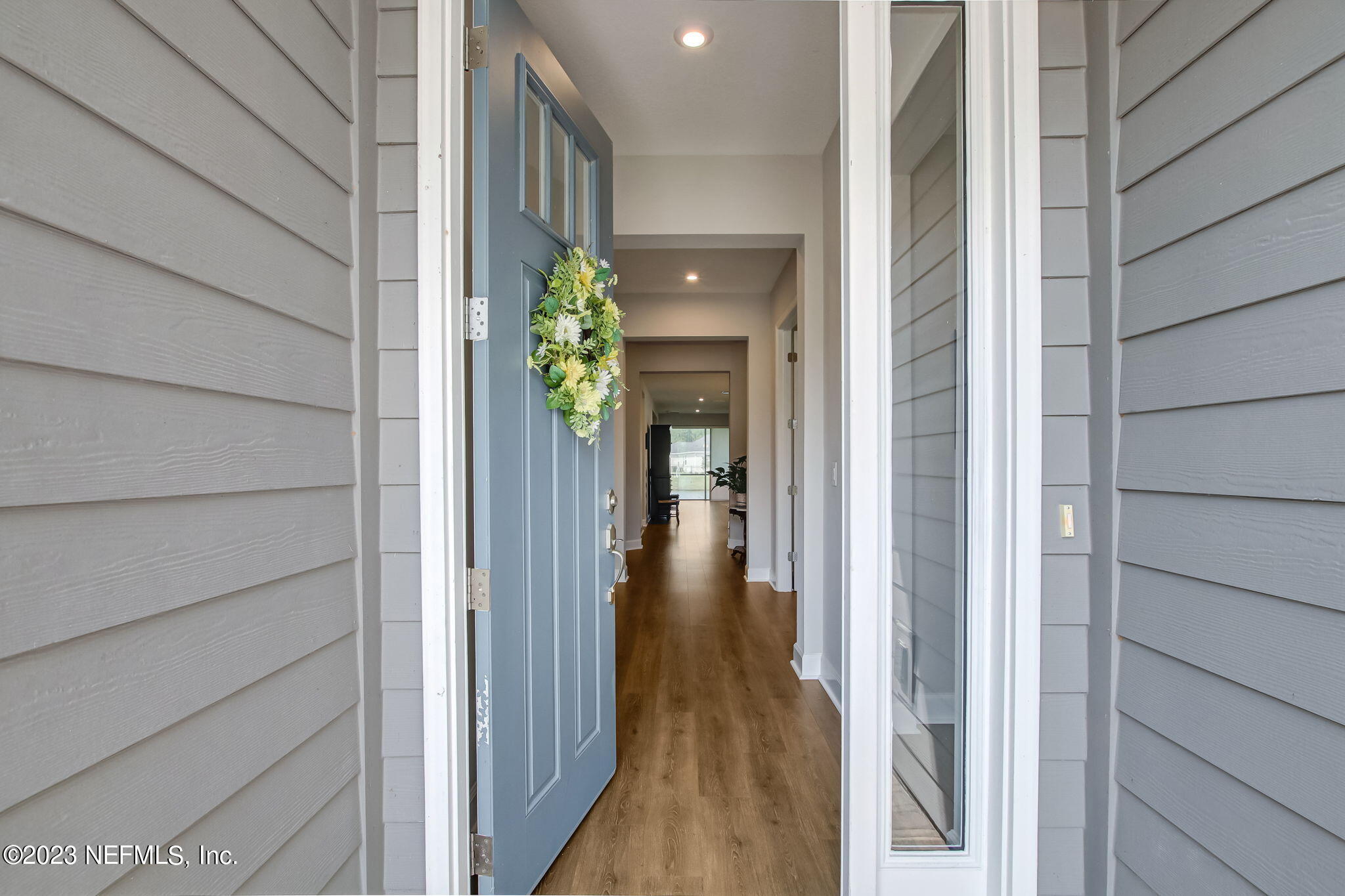 85276 Berryessa Way Yulee, FL 32097 - Photo 2 of 42 a view of a hallway with wooden walls and plants