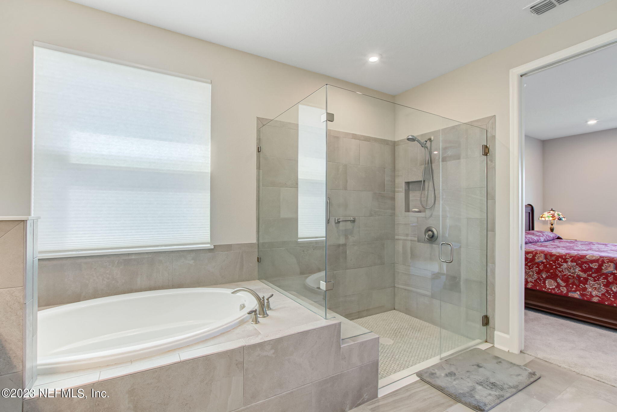 85276 Berryessa Way Yulee, FL 32097 - Photo 24 of 42 a bathroom with a bathtub and a shower