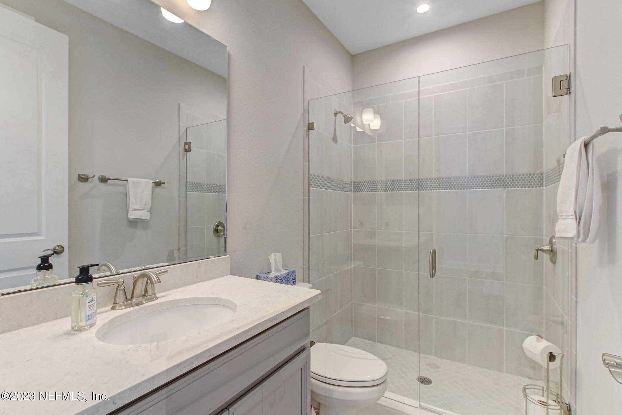 85276 Berryessa Way Yulee, FL 32097 - Photo 27 of 42 a bathroom with a granite countertop sink a toilet and shower