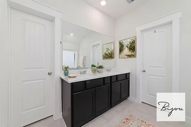 a bathroom with a sink vanity and a mirror