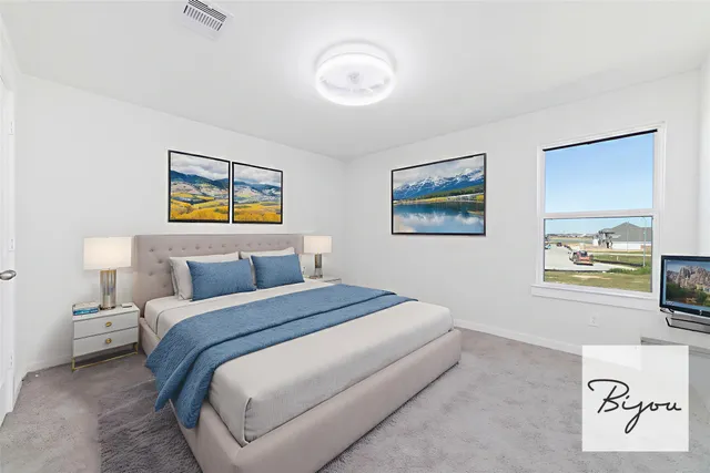 a bedroom with a bed and a painting on the wall