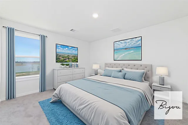 a bedroom with a bed and a painting on the wall