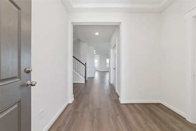 a view of a hallway with wooden floor