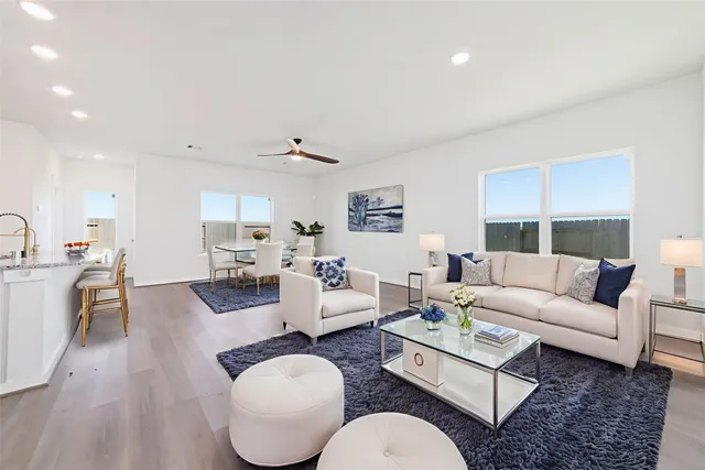 a living room with furniture a view of bedroom and a couch