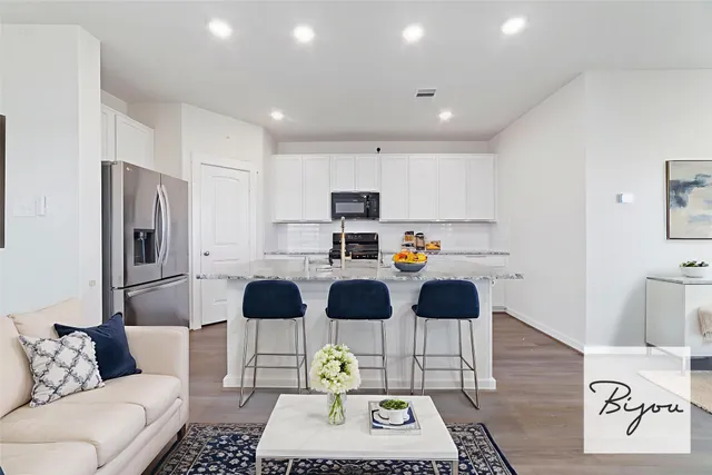 a living room with furniture and a wooden floor