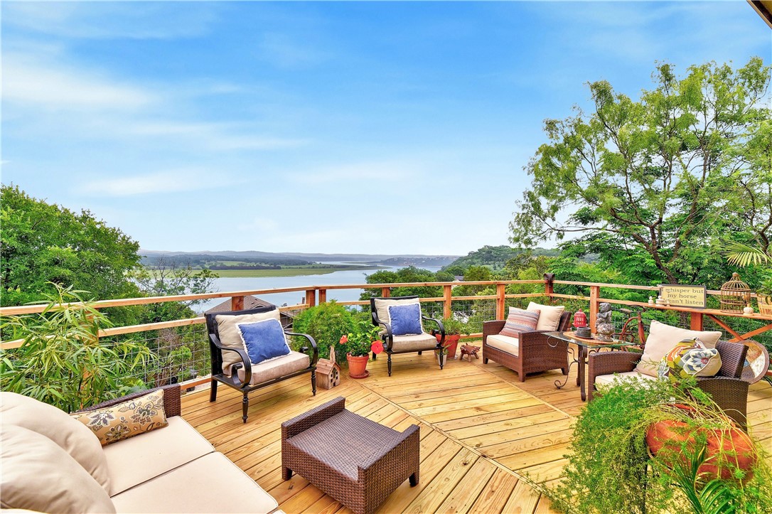 a view of roof deck with couches and city view