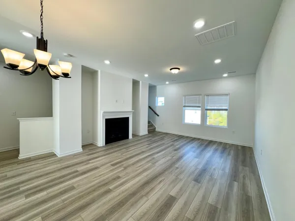 a view of a room with wooden floor and fireplace