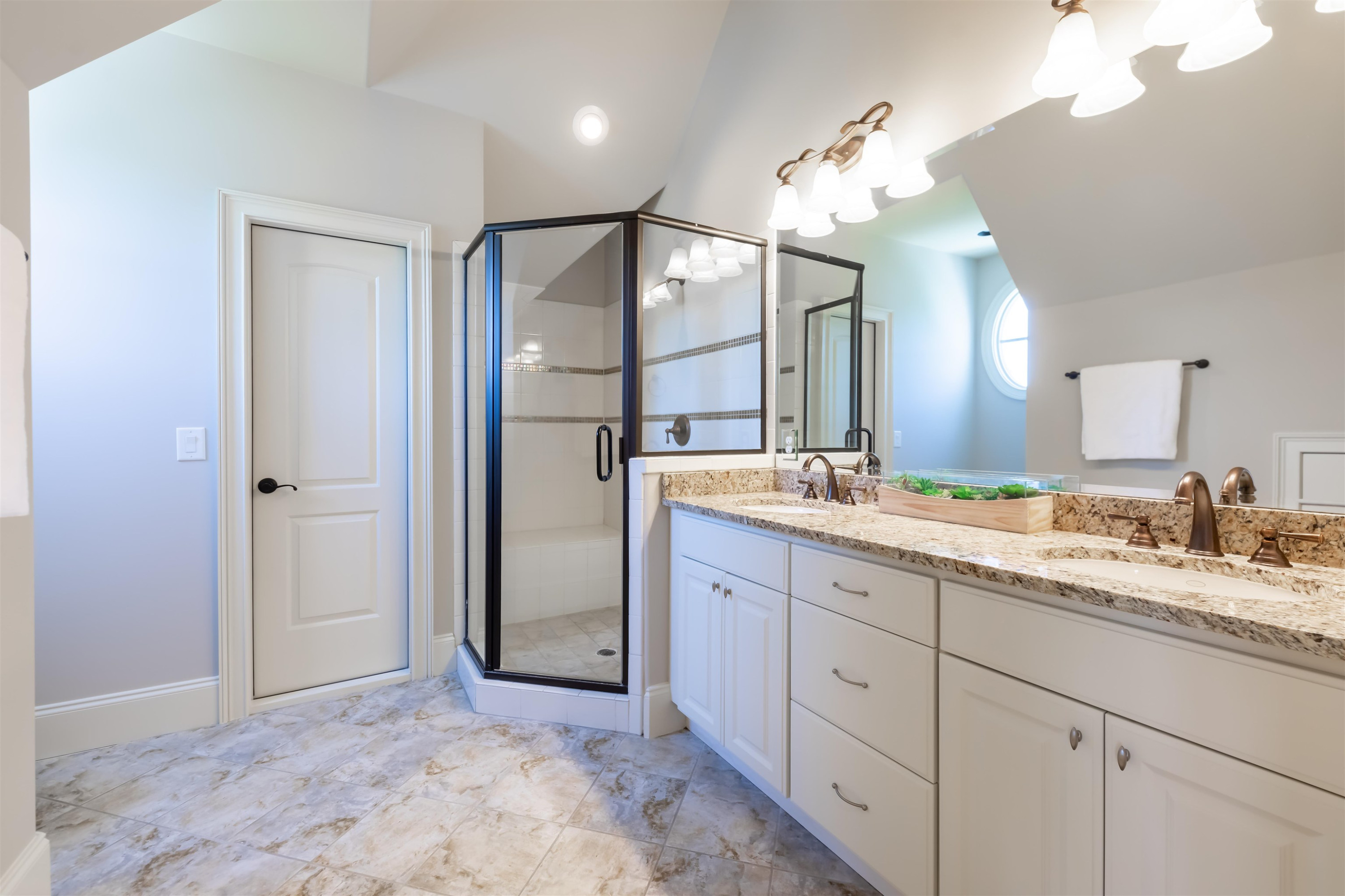 9805 Najma Street Raleigh, NC 27613 - Photo 24 of 30 The bathroom to the front bedroom has a walk in shower. The bathroom to the back bedroom has a tub/shower combo and can be accessed from the bedroom or the hall. Bathroom