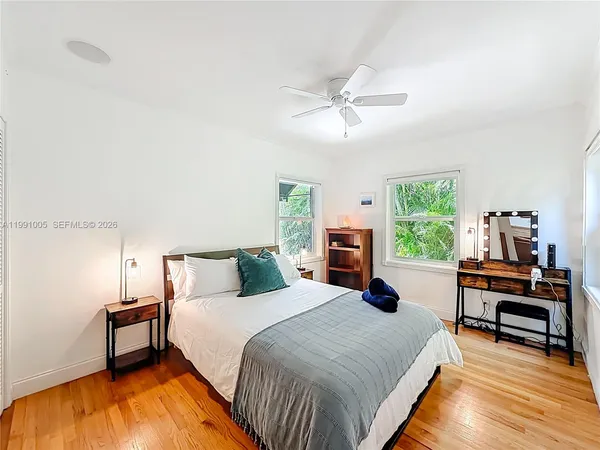 a bedroom with a bed and a view of kitchen