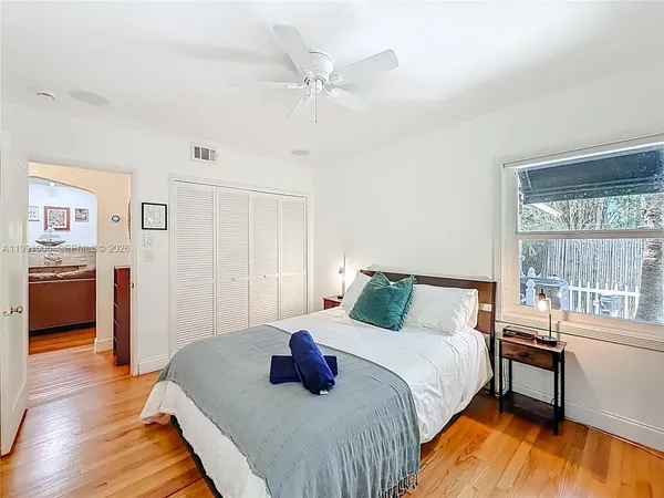 a bedroom with a bed and a window