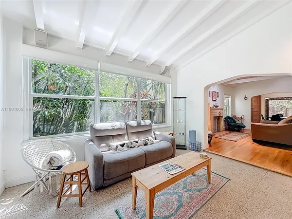 a dining room with furniture and a floor to ceiling window