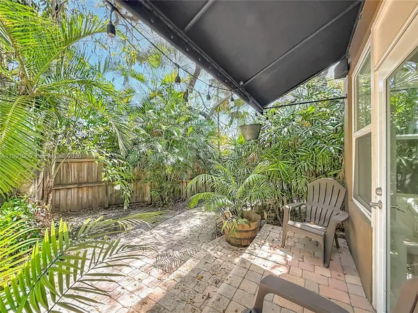 a view of a patio with table and chairs and potted plants