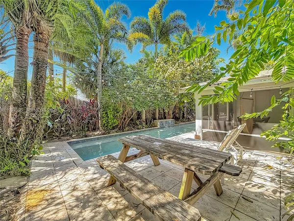 a view of house with backyard outdoor seating and green space