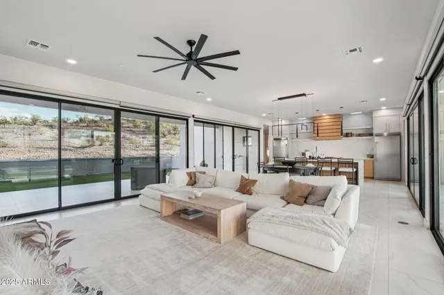 a living room with furniture and large windows