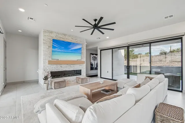 a living room with furniture tv and a large window