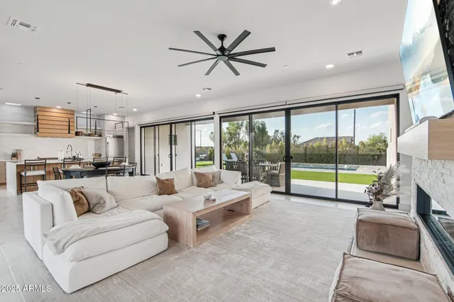 a dinning area with furniture and a large window