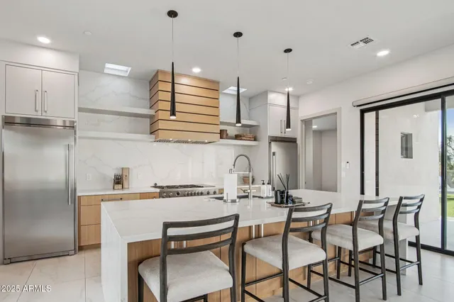 a large white kitchen with a large window
