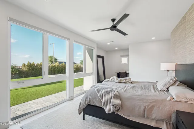 a bedroom with a large bed and a chandelier