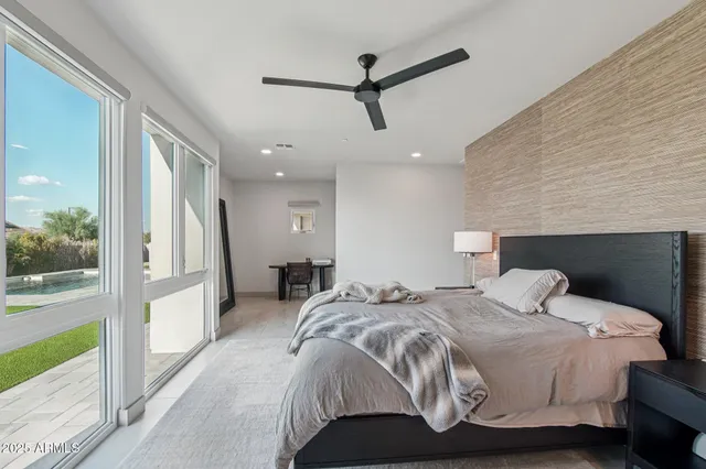 a spacious bathroom with a double vanity sink mirror and bathtub