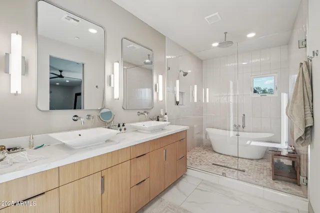 a bathroom with a double vanity sink and mirror