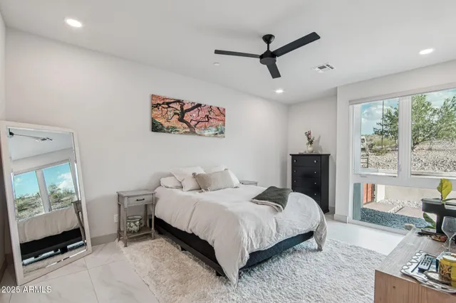 a bedroom with a bed and a potted plant