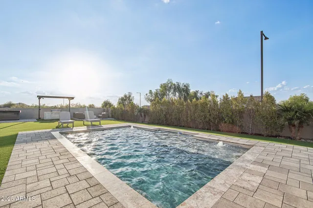 a view of a swimming pool with a yard