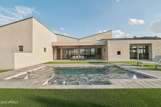 a view of a house with a backyard