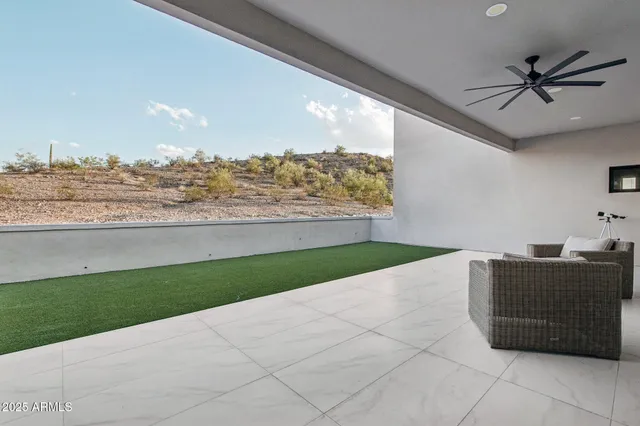 a living room with furniture and a floor to ceiling window