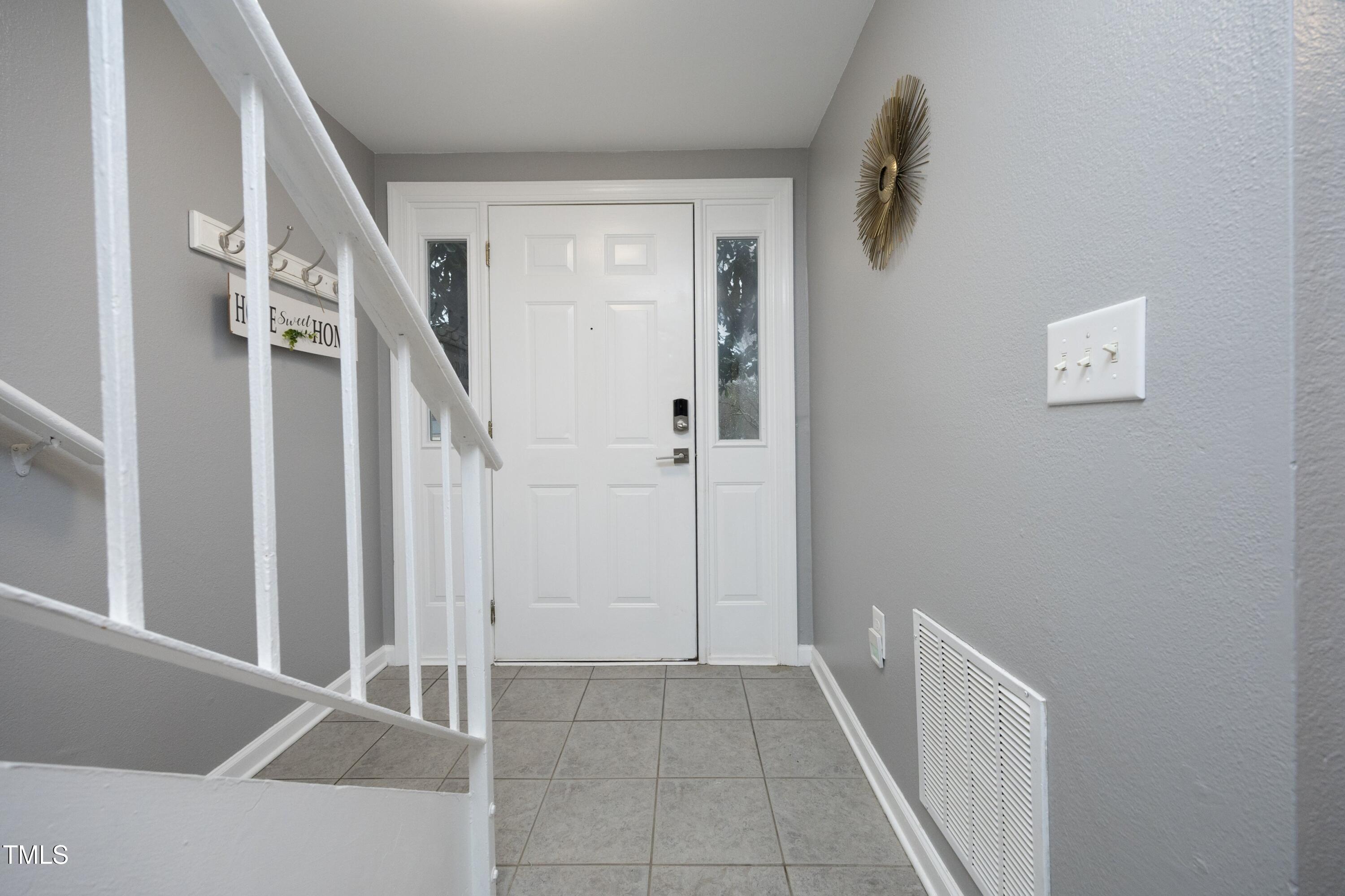 7736 Falcon Rest Circle Raleigh, NC 27615 - Photo 3 of 38 a view of an entryway with staircase