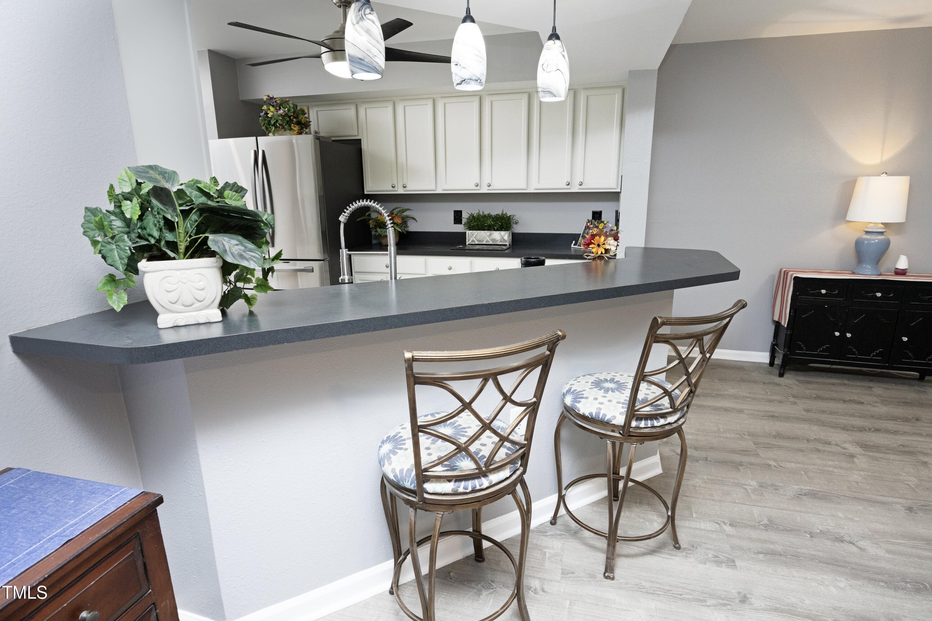 7736 Falcon Rest Circle Raleigh, NC 27615 - Photo 8 of 38 a kitchen with stainless steel appliances a sink a table and chairs