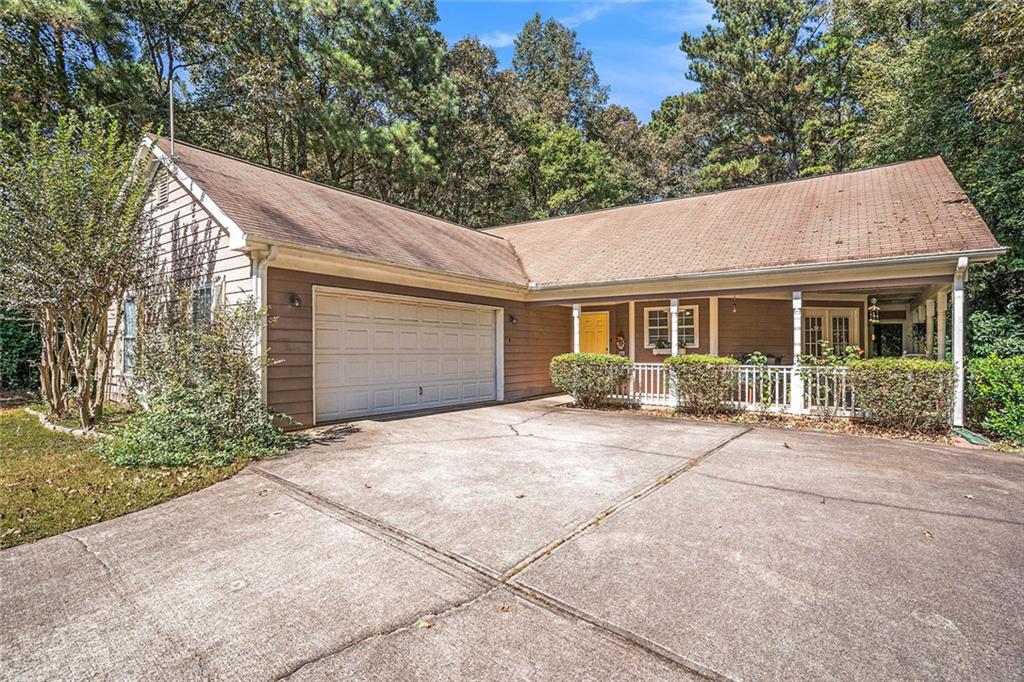a front view of a house with a garden and porch