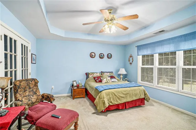 a bedroom with bed and a large window