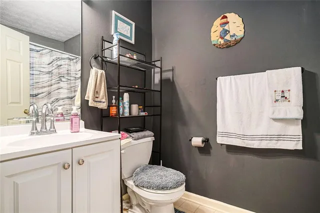 a bathroom with a sink a toilet and a mirror